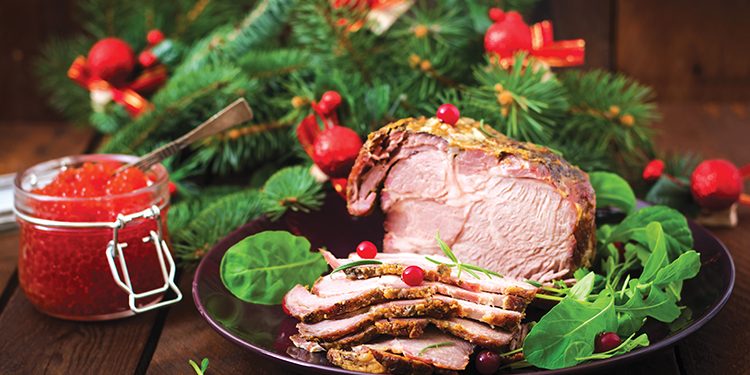 Christmas baked ham and red caviar, served on the old wooden table.