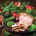 Christmas baked ham and red caviar, served on the old wooden table.