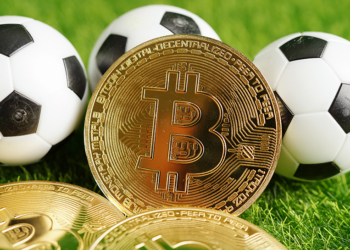 Gold bitcoin with soccer ball or football, cryptocurrency used in online sports betting.