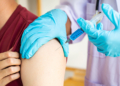 Doctors are vaccinating a new strain of flu patients to prevent the spread of the disease and the epidemic in all ages, Vaccination against communicable diseases concept