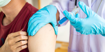 Doctors are vaccinating a new strain of flu patients to prevent the spread of the disease and the epidemic in all ages, Vaccination against communicable diseases concept