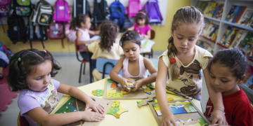 Crianças brincando em uma sala de aula de CMEI em Curitiba, ilustrando o acesso à educação infantil.